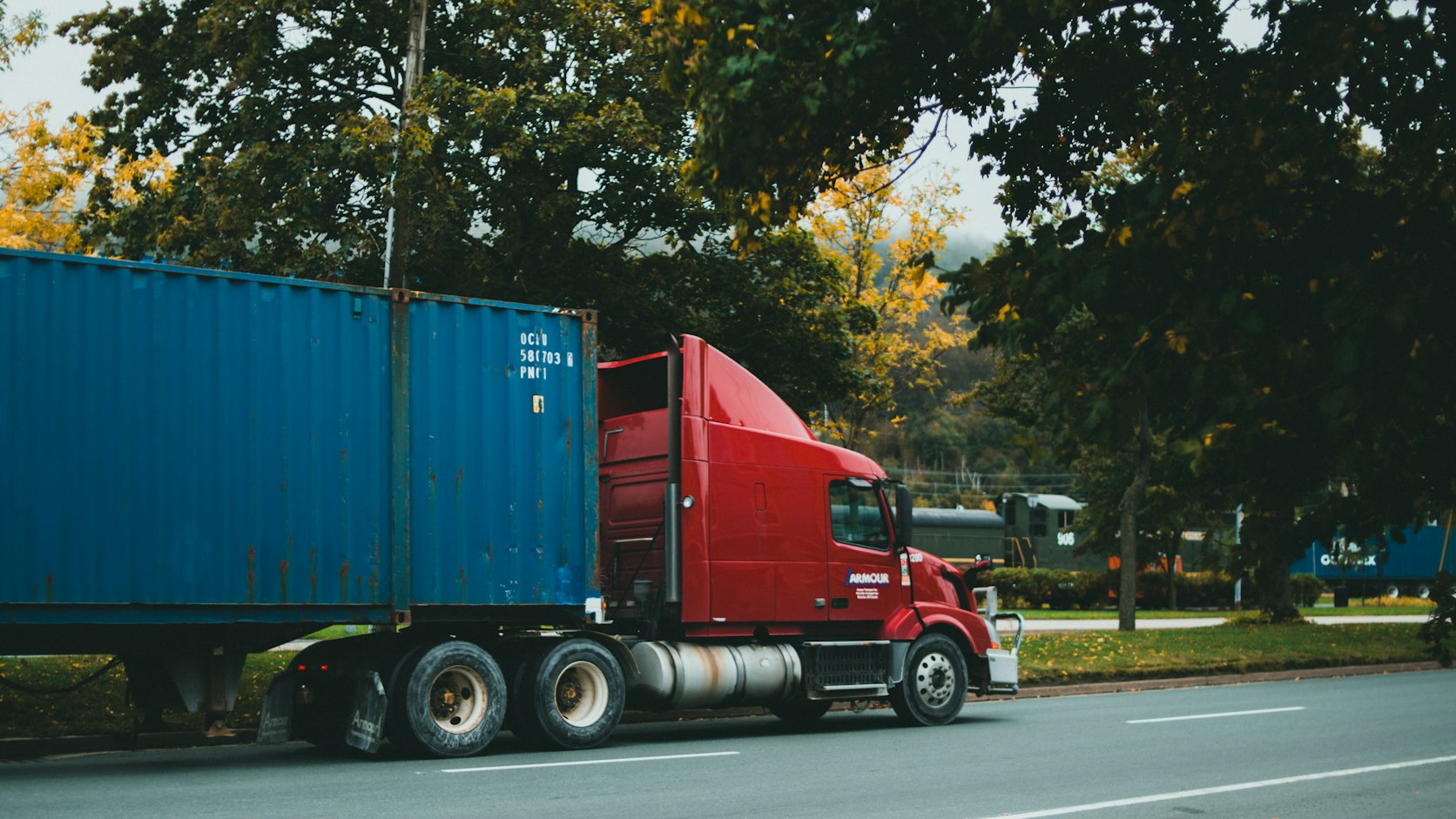Truck hauling a container on a highway